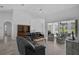 Spacious living room featuring tile floors, vaulted ceilings, and access to the lanai at 8979 Grey Oaks Ave, Sarasota, FL 34238