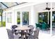 This expansive patio has seating areas, ceiling fans, and views of the exterior at 8979 Grey Oaks Ave, Sarasota, FL 34238