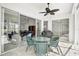 Covered patio features a ceiling fan and outdoor dining area, leading into the home's living space at 8979 Grey Oaks Ave, Sarasota, FL 34238