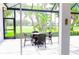 View of the wicker patio set on the lanai overlooking manicured golf course and lush green landscape at 8979 Grey Oaks Ave, Sarasota, FL 34238