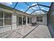 The screened-in patio offers a comfortable outdoor space, seamlessly connecting to the interior of the house at 8979 Grey Oaks Ave, Sarasota, FL 34238