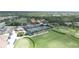 Aerial shot showing community tennis and pool facilities with a golf course nearby, creating an active lifestyle at 8979 Grey Oaks Ave, Sarasota, FL 34238