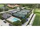 Aerial view of community tennis courts and pool area, offering residents recreational opportunities and social spaces at 8979 Grey Oaks Ave, Sarasota, FL 34238