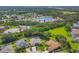 Aerial view of neighborhood highlighting homes, landscaping, and a pond at 9016 30Th E St, Parrish, FL 34219