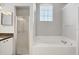 Bright bathroom with shower, soaking tub, and large window at 9016 30Th E St, Parrish, FL 34219