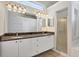 Bathroom featuring a double vanity with granite countertops, plenty of cabinets, and a walk-in shower at 9016 30Th E St, Parrish, FL 34219