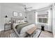 Bright bedroom featuring a ceiling fan, hardwood floors, bench seat, area rug and a large window at 9016 30Th E St, Parrish, FL 34219