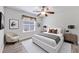 Bright bedroom featuring a ceiling fan, hardwood floors and is furnished with a comfortable bed at 9016 30Th E St, Parrish, FL 34219