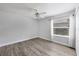 Neutral bedroom offers light colored floors, a large window with bright light, and ceiling fan at 9016 30Th E St, Parrish, FL 34219