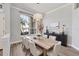 Formal dining room featuring a large window, dining table, and accent furniture at 9016 30Th E St, Parrish, FL 34219