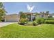 Charming single-story home featuring lush landscaping and a well-manicured lawn at 9016 30Th E St, Parrish, FL 34219