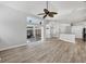 Bright living room featuring a ceiling fan, hardwood floors and sliding glass doors to the outside at 9016 30Th E St, Parrish, FL 34219