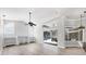 Sun-filled living room with view to the kitchen, pool, and screened patio at 9016 30Th E St, Parrish, FL 34219