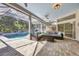 Spacious covered patio featuring a seating area with a gas firepit and view of the pool at 9016 30Th E St, Parrish, FL 34219