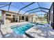 Beautiful pool area with a hot tub, outdoor kitchen, and patio furniture, ideal for relaxation at 9016 30Th E St, Parrish, FL 34219