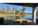 Relaxing backyard view from the covered patio, showcasing a beautiful pond and lush green landscape at 9808 Campanula Ct, Land O Lakes, FL 34637