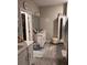 Clean bathroom featuring a white vanity, modern fixtures, and ample storage, providing a functional space at 9808 Campanula Ct, Land O Lakes, FL 34637