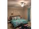 Well-lit bedroom with vibrant bedding, decorative pillows, and stylish wall art, offering a personalized space at 9808 Campanula Ct, Land O Lakes, FL 34637