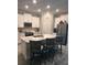 Modern kitchen featuring a large island with seating, stainless steel appliances, and sleek white cabinetry at 9808 Campanula Ct, Land O Lakes, FL 34637