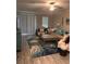 Bright living room with a stylish rug, comfortable seating, and large windows providing natural light at 9808 Campanula Ct, Land O Lakes, FL 34637
