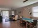 Expansive living room with a tile floor and a view to the dining area at 9808 Campanula Ct, Land O Lakes, FL 34637