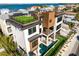 Luxury coastal home featuring a rooftop terrace with artificial turf and great views of the water at 100 6Th S St, Bradenton Beach, FL 34217