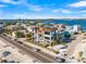 An aerial view of the luxury home featuring a rooftop deck and pool overlooking the beach at 100 6Th S St, Bradenton Beach, FL 34217