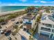Aerial view of an amazing three-story home near the beach featuring a rooftop terrace at 100 6Th S St, Bradenton Beach, FL 34217