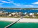 Gorgeous aerial view of a beachfront house near the pier and clear, turquoise waters at 100 6Th S St, Bradenton Beach, FL 34217