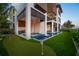 Expansive backyard featuring a putting green, a sparkling pool, and an outdoor kitchen area at 100 6Th S St, Bradenton Beach, FL 34217