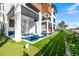 Lovely backyard with a pool, putting green, and outdoor kitchen for ultimate relaxation and entertainment at 100 6Th S St, Bradenton Beach, FL 34217