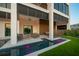 Stunning backyard with a modern patio, chic seating, and a sleek, glowing plunge pool at 100 6Th S St, Bradenton Beach, FL 34217