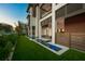 Secluded backyard with a water feature, lush lawn, mature landscaping, and an outdoor seating area at 100 6Th S St, Bradenton Beach, FL 34217