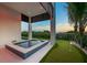 Relaxing backyard oasis with putting green, a refreshing pool, and lush tropical landscaping at 100 6Th S St, Bradenton Beach, FL 34217