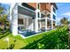 Inviting backyard featuring a sparkling pool, jacuzzi, outdoor kitchen, and putting green at 100 6Th S St, Bradenton Beach, FL 34217