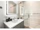 Elegant bathroom featuring glass-enclosed tub/shower combination at 100 6Th S St, Bradenton Beach, FL 34217