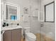 Modern bathroom features a glass-enclosed shower and a sleek vanity with a lighted mirror at 100 6Th S St, Bradenton Beach, FL 34217