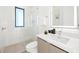 This modern bathroom features a glass-enclosed shower and sleek vanity with a lighted mirror at 100 6Th S St, Bradenton Beach, FL 34217