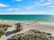 Coastal view of a pristine beach, complete with a lifeguard station and pier, perfect for relaxation at 100 6Th S St, Bradenton Beach, FL 34217