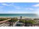 Relaxing beach view showcases the coastline and lifeguard tower, as seen from a railing above the sandy shore at 100 6Th S St, Bradenton Beach, FL 34217