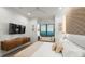 Bright bedroom featuring ocean views, a flat-screen TV, and stylish contemporary furnishings at 100 6Th S St, Bradenton Beach, FL 34217