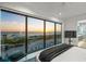 Serene primary bedroom boasting an ocean view, wall-mounted TV, and contemporary style at 100 6Th S St, Bradenton Beach, FL 34217