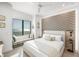 Bedroom featuring neutral tones, ocean view window, and sleek bedside lighting at 100 6Th S St, Bradenton Beach, FL 34217
