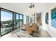Open-concept dining area with sliding glass doors to oceanfront balcony at 100 6Th S St, Bradenton Beach, FL 34217