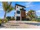 Stunning modern beachfront home featuring a sleek design with wood accents and a private two-car garage at 100 6Th S St, Bradenton Beach, FL 34217