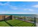 Inviting rooftop deck featuring artificial grass, sleek railings and serene ocean views, perfect for relaxation and entertainment at 100 6Th S St, Bradenton Beach, FL 34217