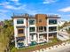 Beautifully designed modern home featuring a refreshing pool, spa, balcony, and lush landscaping at 100 6Th S St, Bradenton Beach, FL 34217