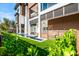 Modern home featuring a beautiful water feature, a manicured lawn, and privacy fencing at 100 6Th S St, Bradenton Beach, FL 34217