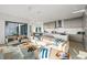 Bright and open living room with modern furniture, stylish decor, and access to the outdoor living area at 100 6Th S St, Bradenton Beach, FL 34217