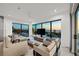 Modern living room with contemporary furnishings, large windows, and a beautiful ocean view, creating a relaxing and stylish atmosphere at 100 6Th S St, Bradenton Beach, FL 34217